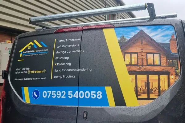 Rear doors of the van: Paul Hadfield logo, seven services, phone number 07592 540058 and a photo of a finished house